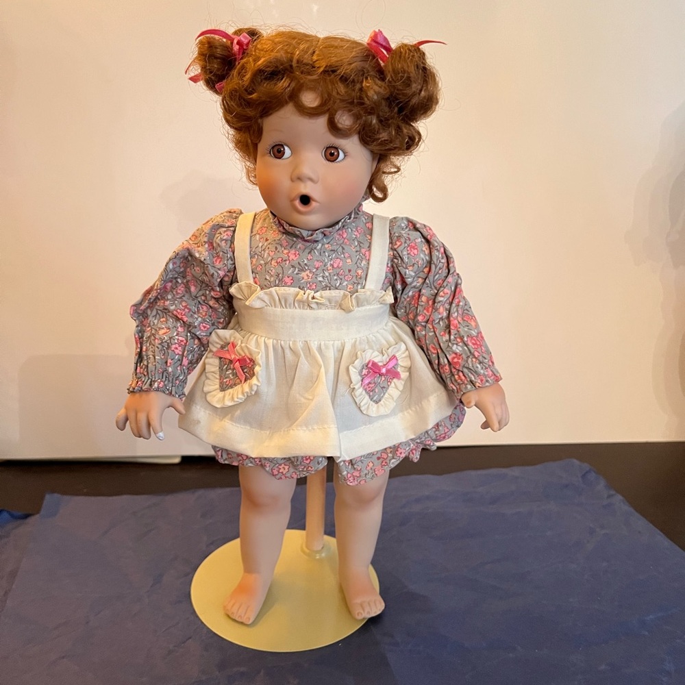 Vtg Red Head Porcelain Doll on stand. Soft torso and posable arms. 12” high